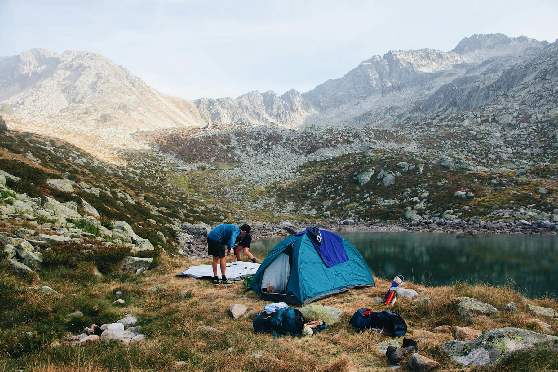 Camping by a serene lake in Barèges, France, surrounded by majestic mountains. on The Frugal Camper