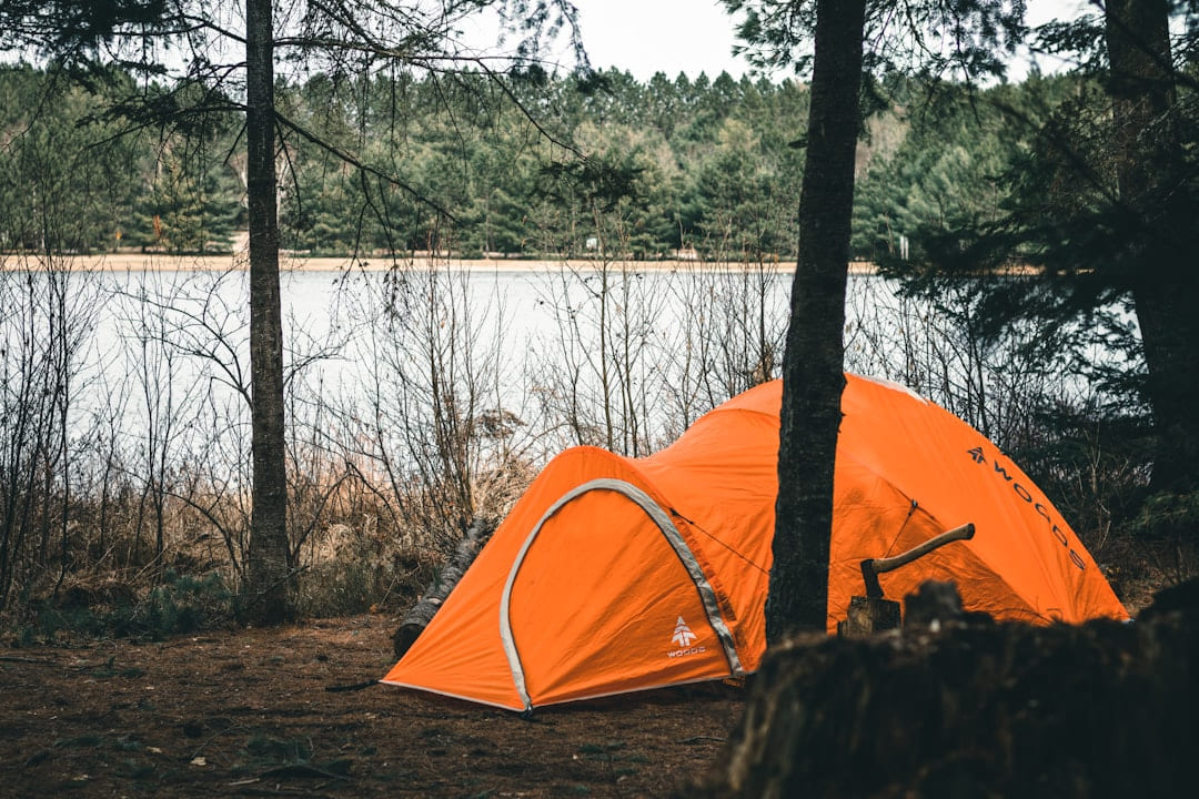 a tent on a rock by a lake on The Frugal Camper