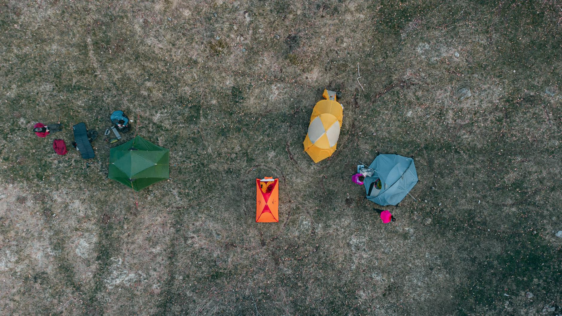 Drone shot showing colorful tents set up on grassy terrain in Ukraine. on The Frugal Camper