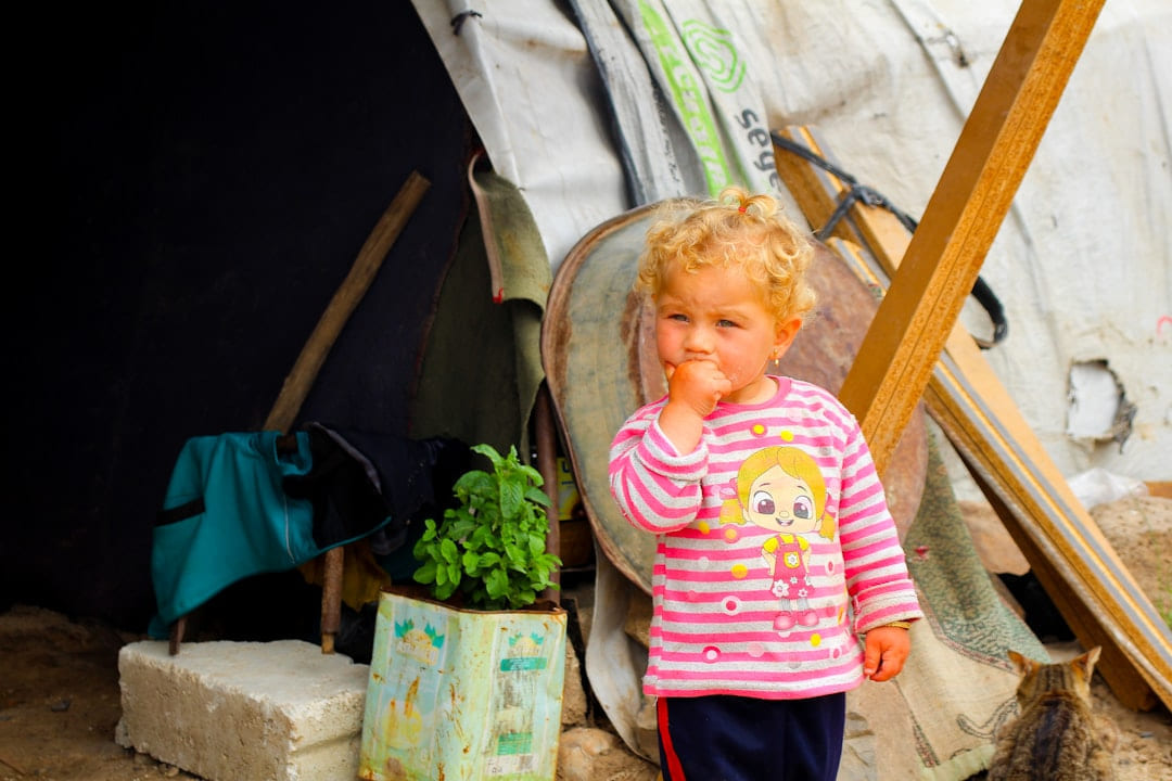 A little boy standing in front of a tent on The Frugal Camper